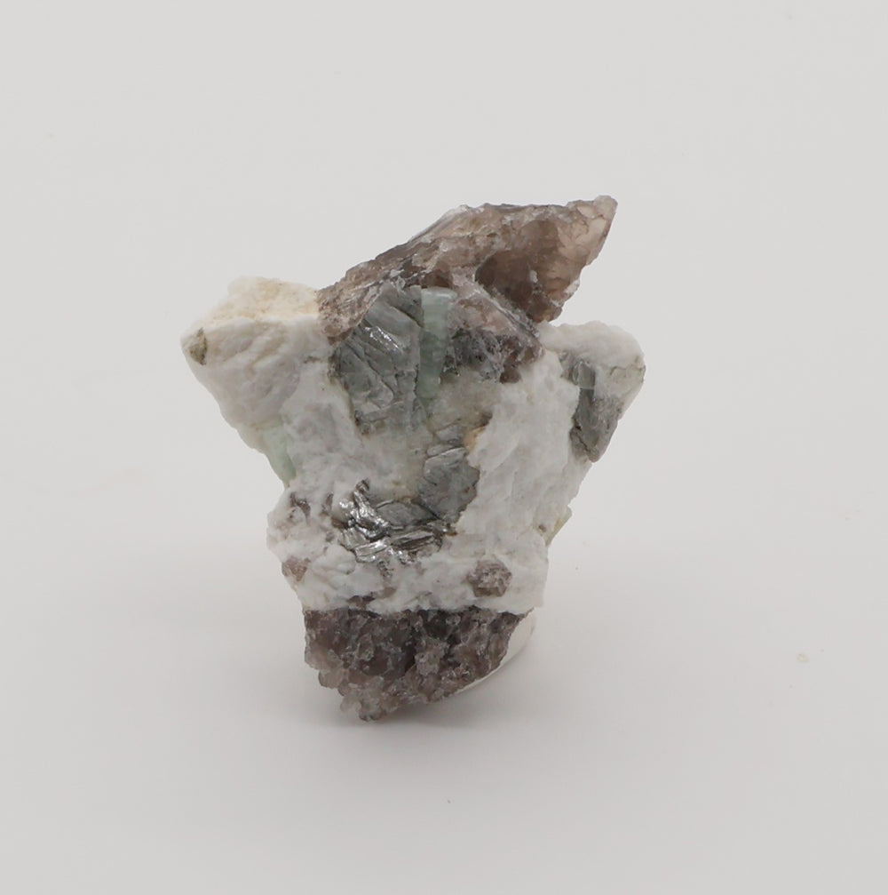Aquamarine and Heliodor with Mica, Hematite, on Smoky Quartz and Feldspar